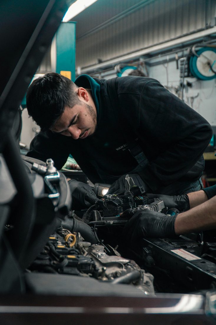 An ASE-trained technician working on a car's brakes at Northside Auto