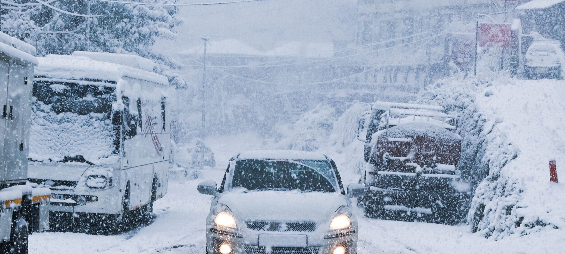 A salt-covered car on a snowy Minneapolis street in winter